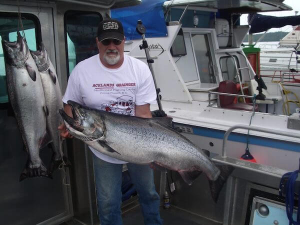 Captain Mark with huge salmon on boat